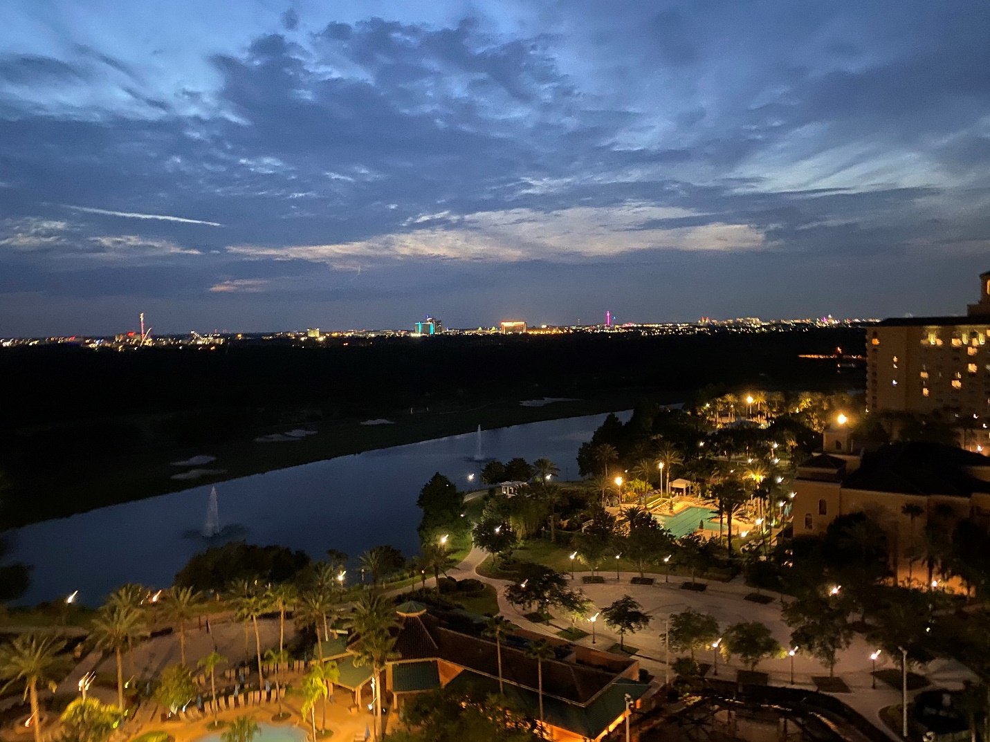 A city at night with a river Description automatically generated