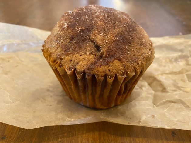 A brown cupcake on a white surface
Description automatically generated with low confidence