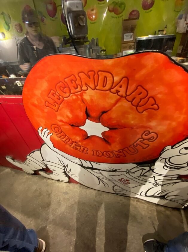 A large orange and white sign
Description automatically generated