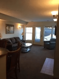 A living room with a couch and a table
Description automatically generated