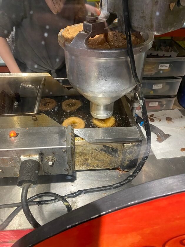 A machine with donuts being made
Description automatically generated