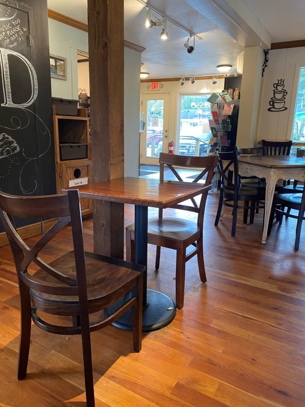 A table and chairs in a restaurant
Description automatically generated