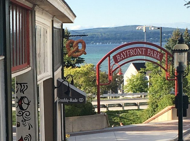 side walk over looking Bayfront Park sign and Little Traverse Bay.