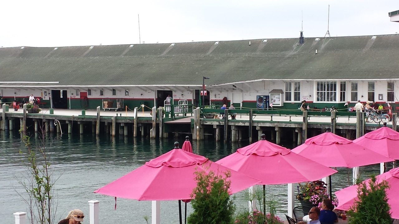 A building with pink umbrellas
Description automatically generated